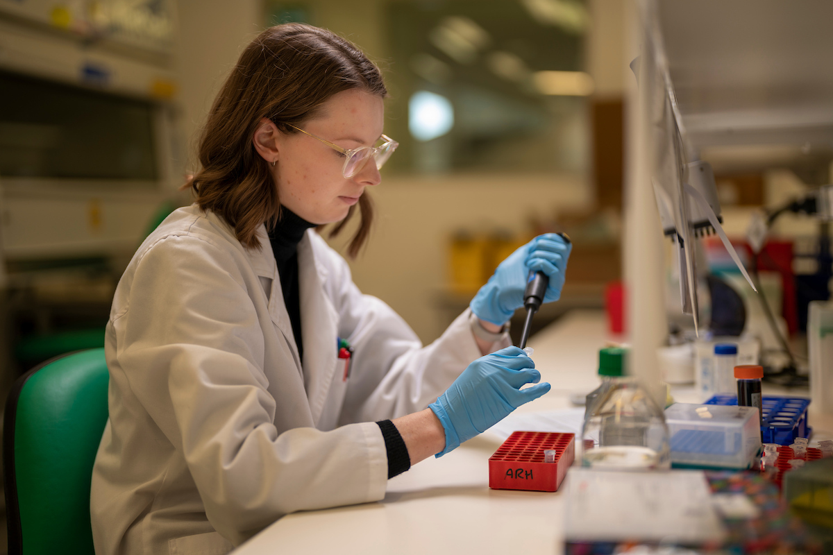 Dr Samantha McGaughey is a postdoctoral fellow at The Australian National University. Photo: Jamie Kidston/ANU Woman in a lab coat using pippette