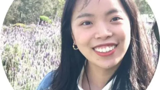 A young woman smiling in a field of lavender.